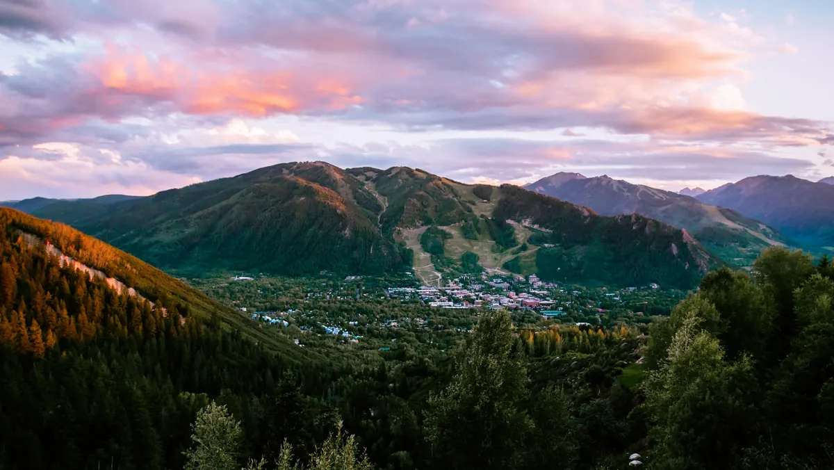 Aspen and Aspen Mountain at dusk, seen from the forested hills above town
