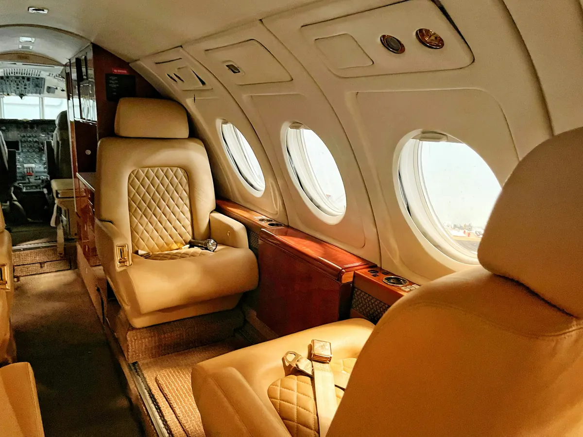 Private jet cabin with quilted leather seats in warm window light